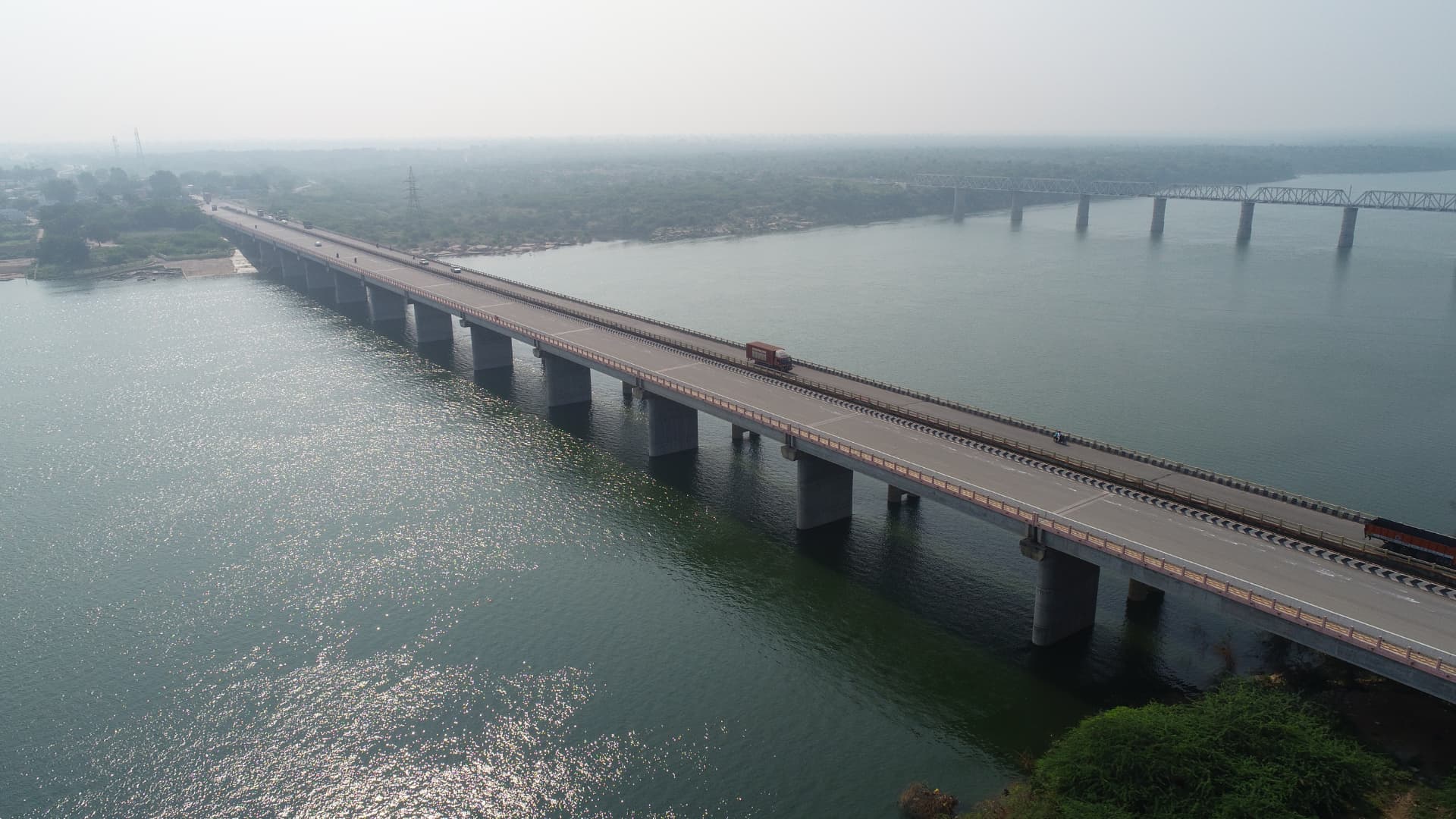 Aerial view of a road bridge spanning a wide river